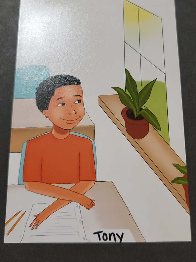 Tony at his desk in the classroom